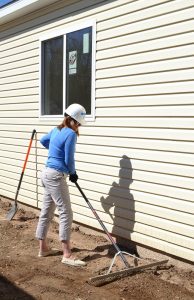 DHS Executive Director Julie Krow works at a Pikes Peak Habitat for Humanity home site in Fountain.