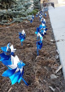 Pinwheels are planted in front of Centennial Hall in downtown Colorado Springs on Monday, April 12, 2021. Blue pinwheels symbolize the happy childhood desired for all children and are the symbols for national Child Abuse Prevention Month in April.